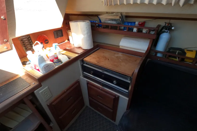 Slide: The Image of Interior of a 1983 Catalina 25 sailboat galley with stove and storage. - 11