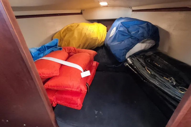 Slide: The Image of Interior cabin of 1983 Catalina 25 sailboat with colorful gear and equipment. - 12