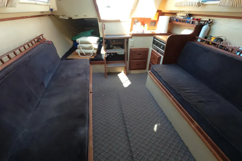 Slide: The Image of Interior of a 1983 Catalina 25 sailboat with seating and storage. - 15