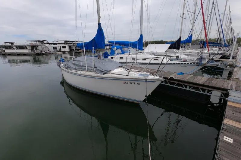 Slide: The Image of 1983 Catalina 25 sailboat docked at marina, covered and ready for sailing. - 2