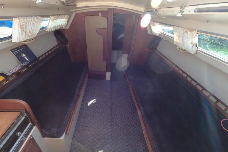 Slide: The Image of Interior of a 1983 Catalina 25 sailboat with seating and windows. - 7