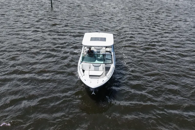 Slide: The Image of 2022 Chaparral 280 OSX boat cruising on open water, aerial view. - 17