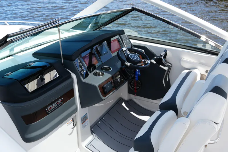 Slide: The Image of 2022 Chaparral 280 OSX boat cockpit with modern controls and dual seating. - 21