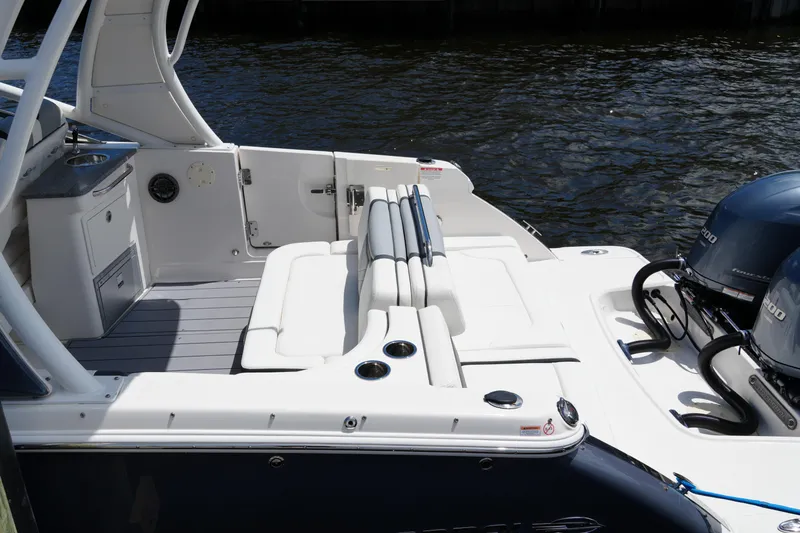 Slide: The Image of 2022 Chaparral 280 OSX boat interior with seating and twin engines on water. - 22