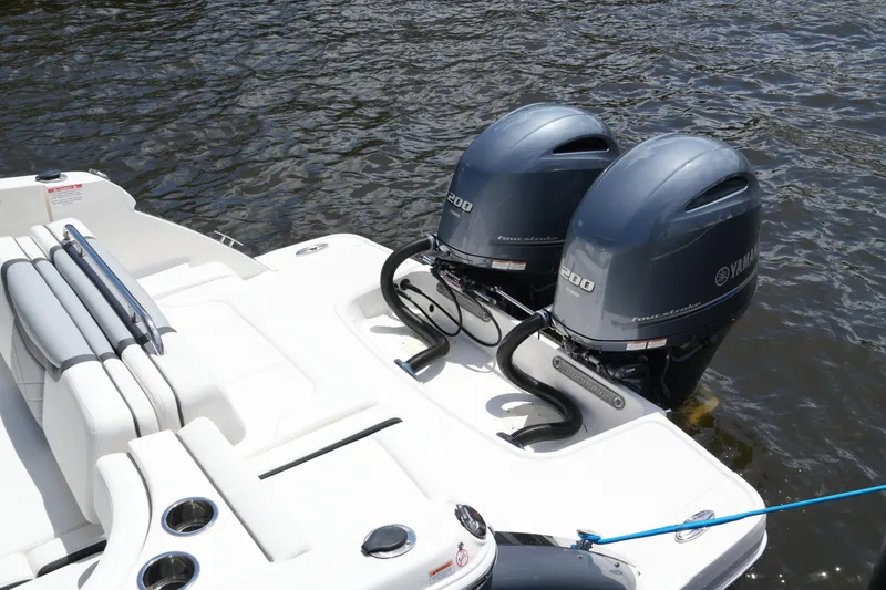 Slide: The Image of 2022 Chaparral 280 OSX boat with twin Yamaha outboard engines on water. - 23