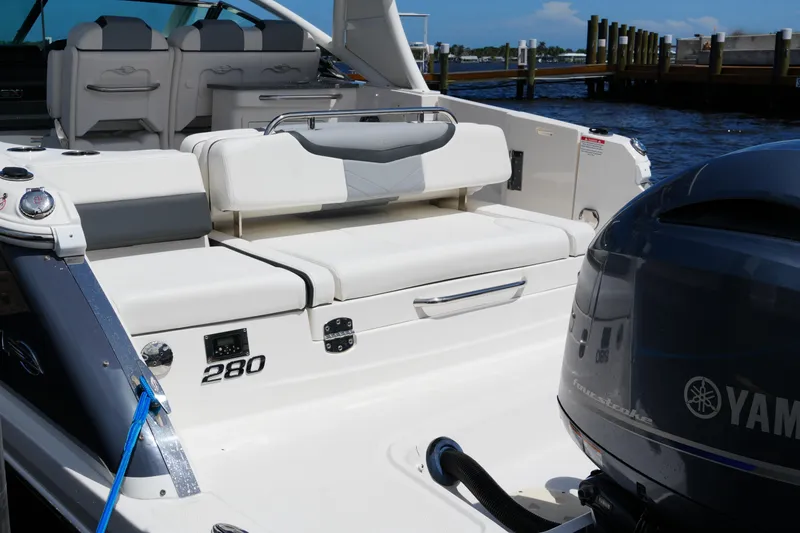 Slide: The Image of 2022 Chaparral 280 OSX boat with Yamaha engine, docked by the water. - 25