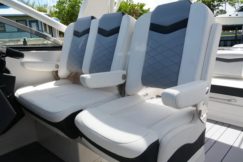 Slide: The Image of Luxury seating on 2022 Chaparral 280 OSX boat, featuring stylish white and gray upholstery. - 27