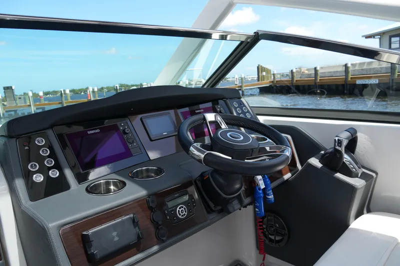 Slide: The Image of 2022 Chaparral 280 OSX helm with modern controls and navigation displays. - 28