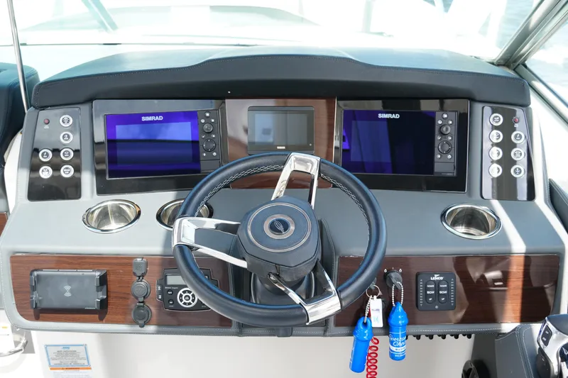 Slide: The Image of Helm of 2022 Chaparral 280 OSX boat with dual Simrad displays and modern controls. - 29