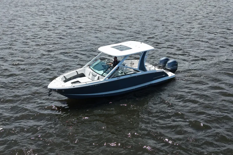 Slide: The Image of 2022 Chaparral 280 OSX boat cruising on open water, featuring sleek design and dual engines. - 3