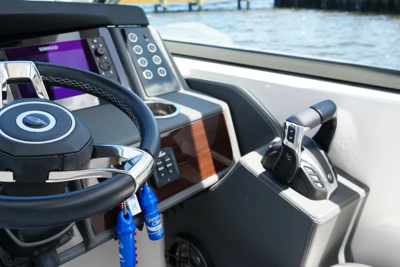 Slide: The Image of 2022 Chaparral 280 OSX boat helm with steering wheel and control panel. - 30
