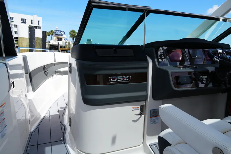 Slide: The Image of 2022 Chaparral 280 OSX boat interior with modern dashboard and seating. - 31