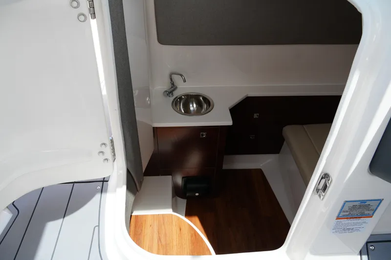 Slide: The Image of Interior cabin of 2022 Chaparral 280 OSX boat with sink and seating area. - 32