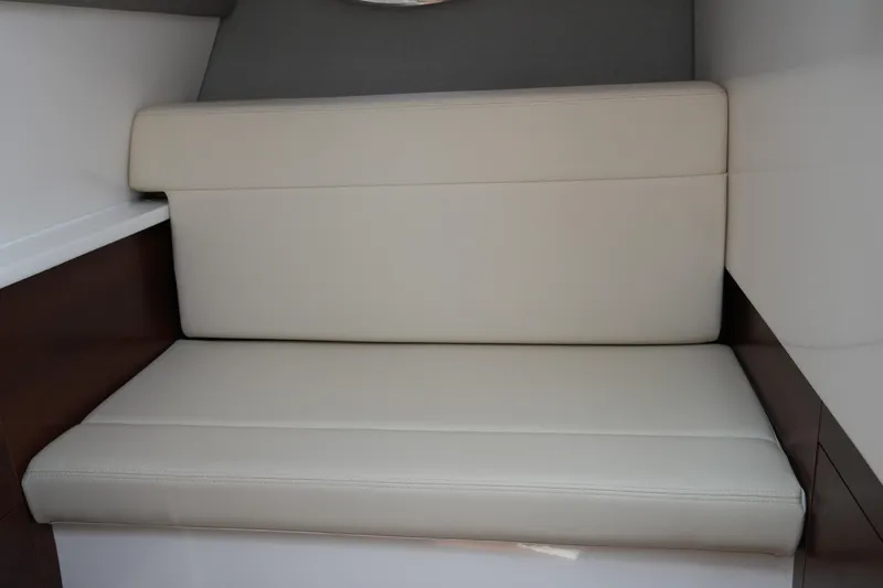 Slide: The Image of 2022 Chaparral 280 OSX interior with beige cushioned seating. - 33