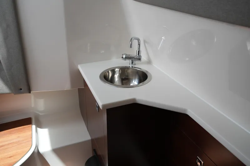 Slide: The Image of 2022 Chaparral 280 OSX boat interior with sleek sink and modern faucet. - 34
