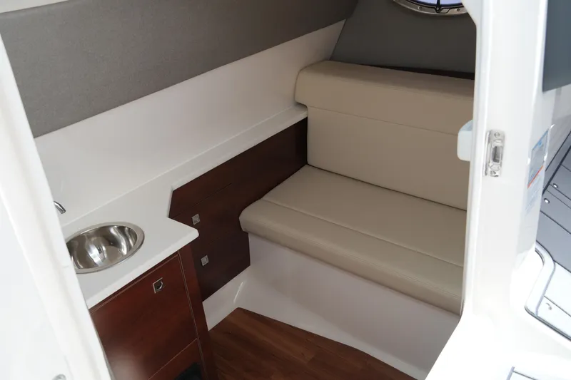 Slide: The Image of 2022 Chaparral 280 OSX cabin interior with seating and sink. - 35