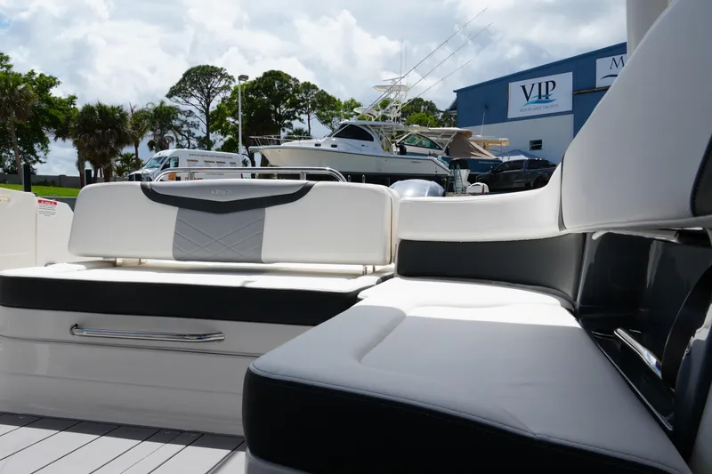 Slide: The Image of 2022 Chaparral 280 OSX boat interior with sleek seating, parked near VIP Boats and Yachts. - 37