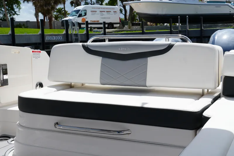 Slide: The Image of 2022 Chaparral 280 OSX boat interior with sleek white seating and modern design. - 44