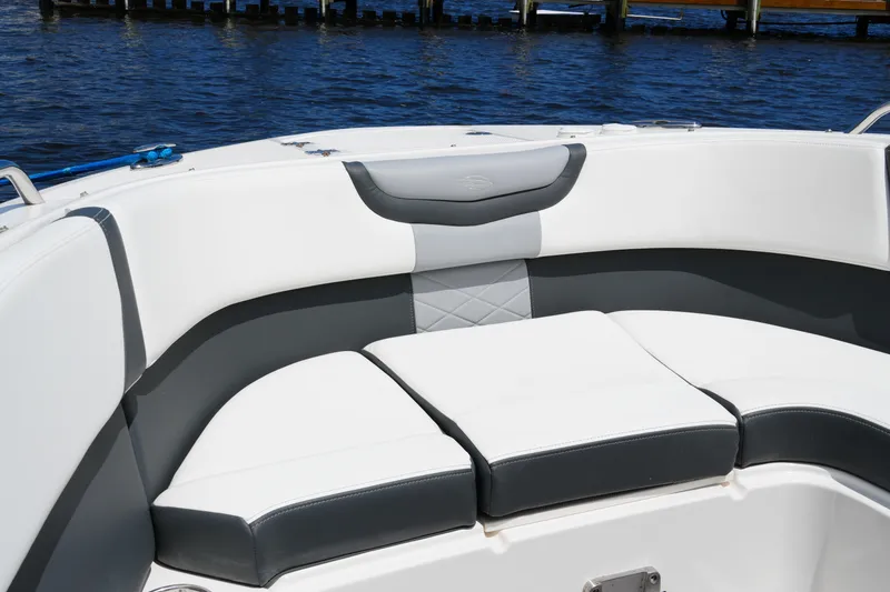 Slide: The Image of 2022 Chaparral 280 OSX boat with luxurious white and gray seating by the water. - 47