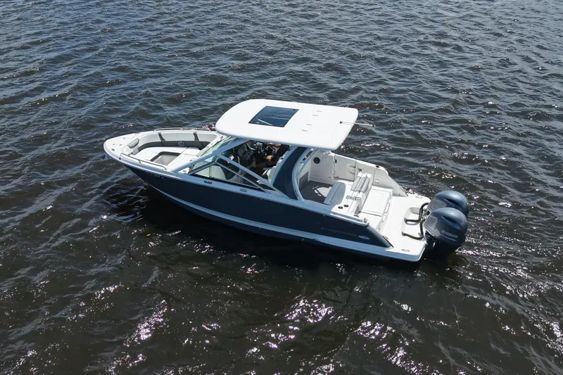 Slide: The Image of 2022 Chaparral 280 OSX boat on water, featuring sleek design and dual outboard engines. - 5