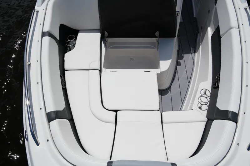 Slide: The Image of 2022 Chaparral 280 OSX boat interior with white cushioned seating and cup holders. - 50