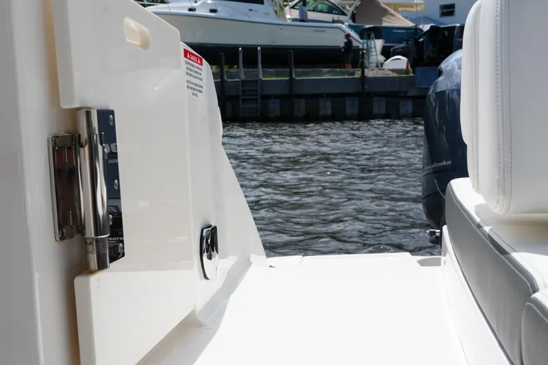 Slide: The Image of 2022 Chaparral 280 OSX boat interior with water view and docked boats. - 58