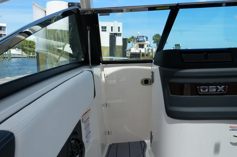 Slide: The Image of Interior view of 2022 Chaparral 280 OSX boat, featuring sleek design and waterfront backdrop. - 59