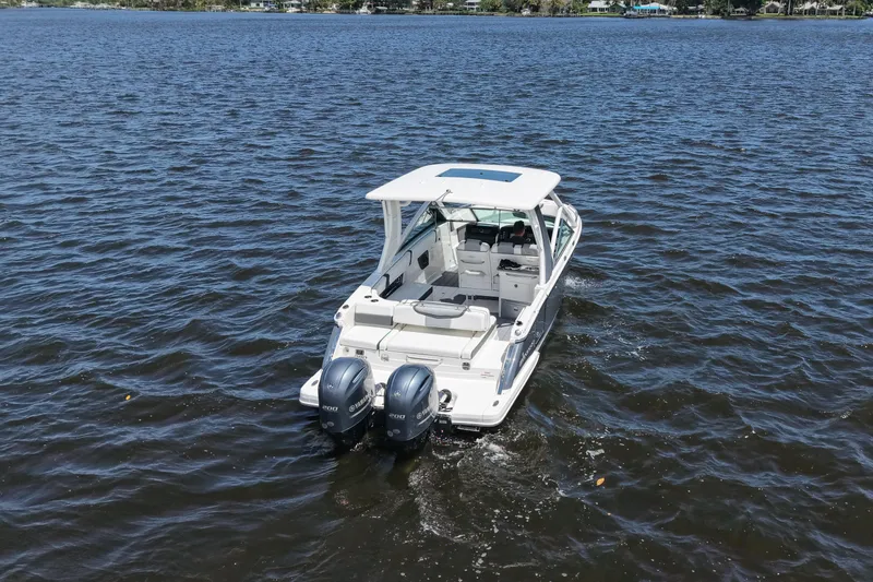 Slide: The Image of 2022 Chaparral 280 OSX boat cruising on open water, rear view. - 6