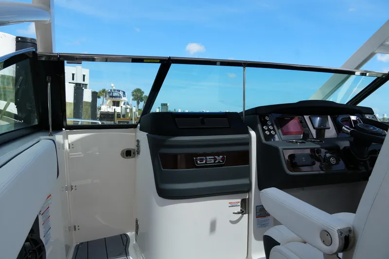 Slide: The Image of 2022 Chaparral 280 OSX boat cockpit with modern controls and steering wheel. - 60