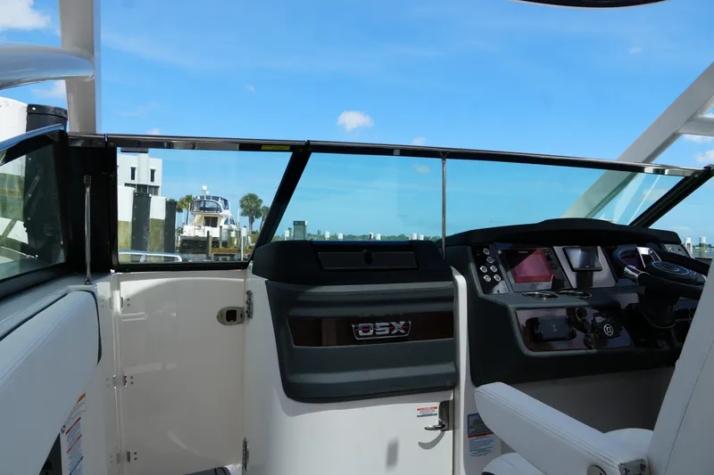 Slide: The Image of Interior view of 2022 Chaparral 280 OSX boat cockpit with modern controls. - 61