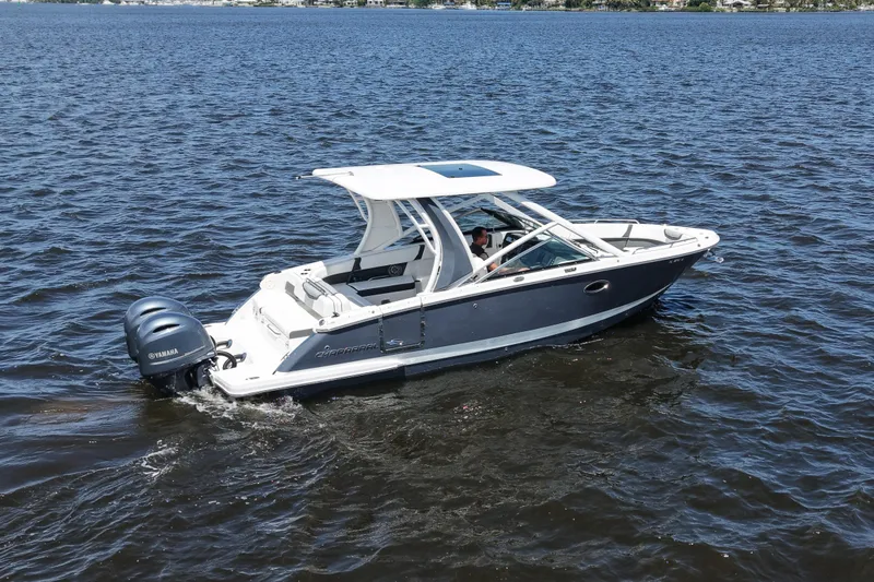 Slide: The Image of 2022 Chaparral 280 OSX boat cruising on open water with Yamaha engines. - 7