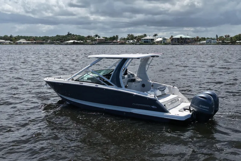 Slide: The Image of 2022 Chaparral 280 OSX boat on water, featuring sleek design and dual Yamaha engines. - 9