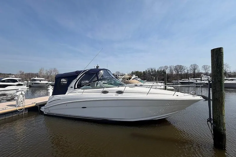 Slide: The Image of 2007 Sea Ray 300 Sundancer docked at marina under clear blue sky. - 1