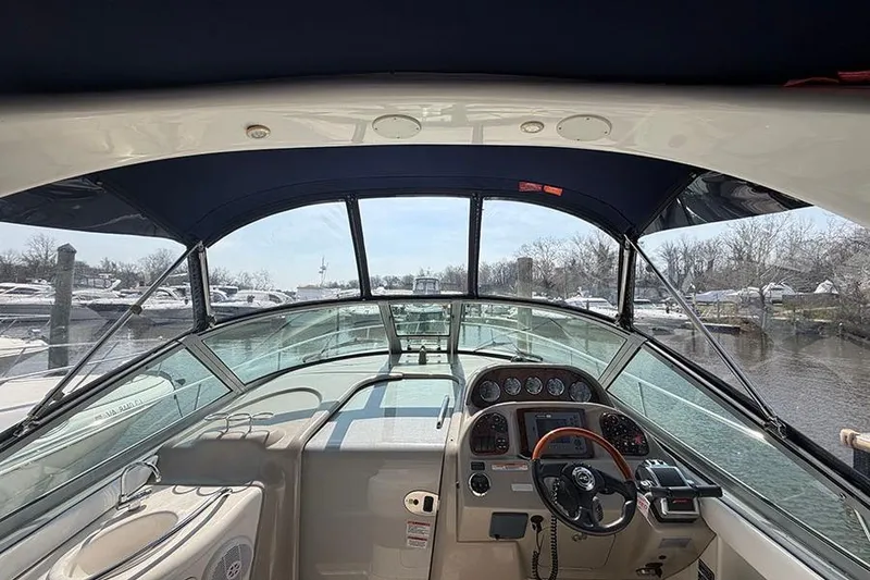 Slide: The Image of Interior view of 2007 Sea Ray 300 Sundancer boat cockpit with steering wheel. - 14