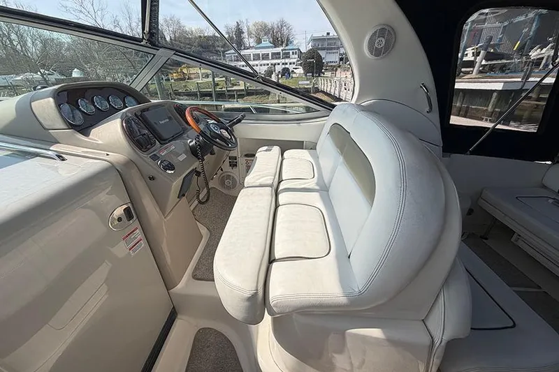 Slide: The Image of Interior of a 2007 Sea Ray 300 Sundancer boat with helm and seating area. - 15