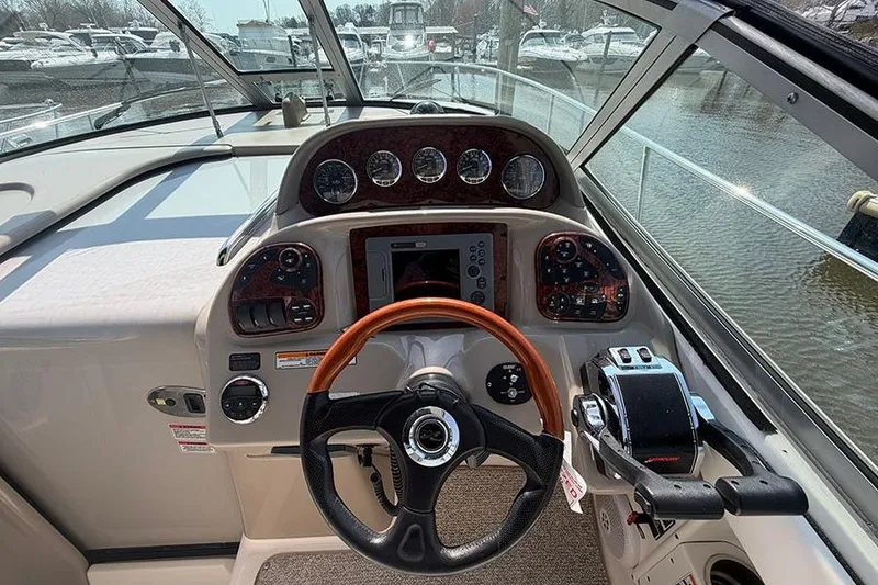 Slide: The Image of Cockpit view of 2007 Sea Ray 300 Sundancer with steering wheel and control panel. - 17