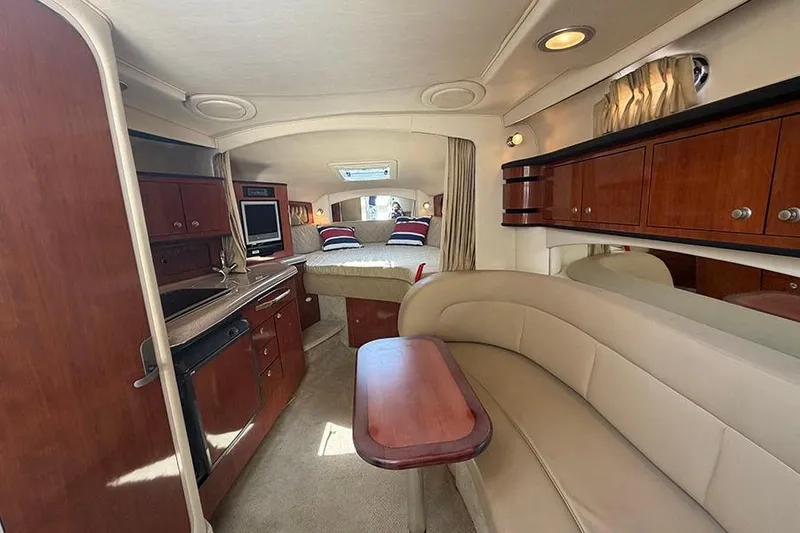 Slide: The Image of Interior of 2007 Sea Ray 300 Sundancer yacht with cozy seating and wooden cabinetry. - 18