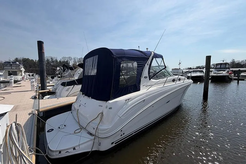 Slide: The Image of 2007 Sea Ray 300 Sundancer docked at marina under clear sky. - 2