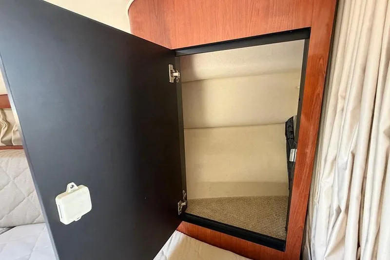 Slide: The Image of Open storage compartment inside 2007 Sea Ray 300 Sundancer boat cabin. - 22