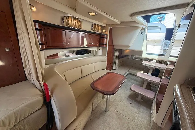 Slide: The Image of Interior of 2007 Sea Ray 300 Sundancer yacht with seating and wooden cabinetry. - 24