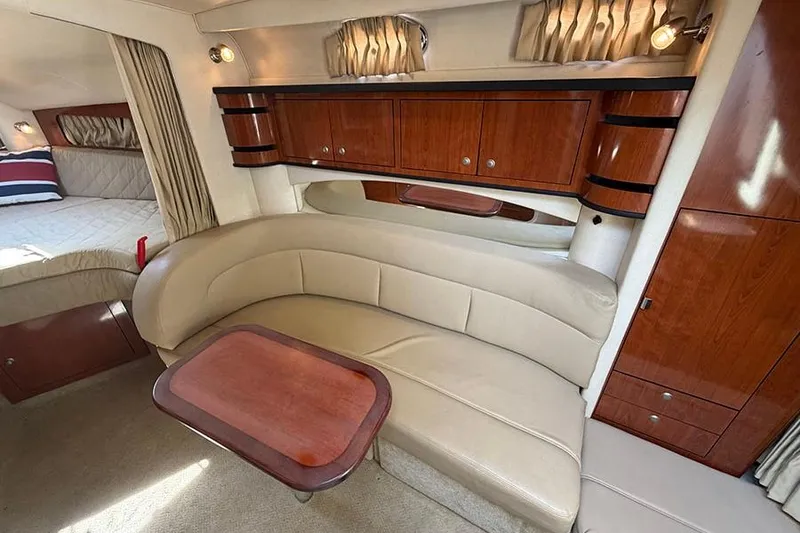 Slide: The Image of Interior of 2007 Sea Ray 300 Sundancer with beige seating and wooden cabinetry. - 26