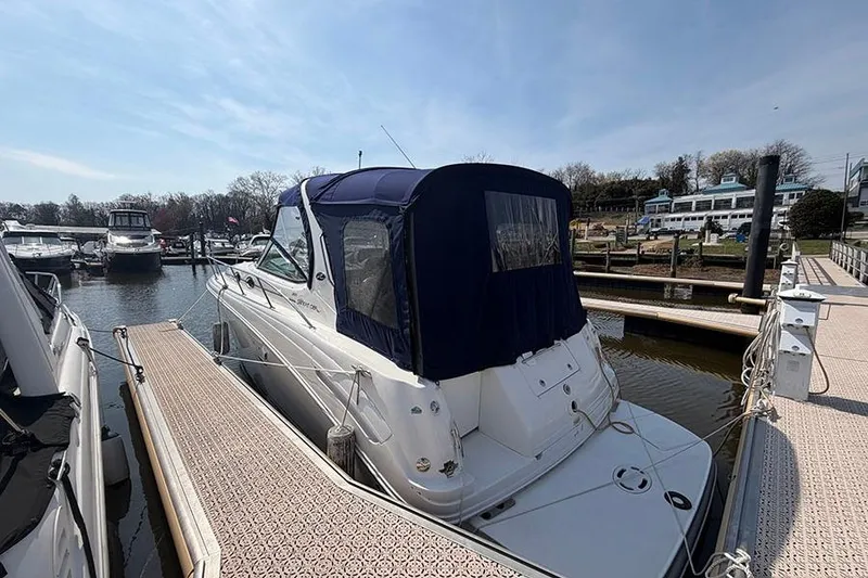 Slide: The Image of 2007 Sea Ray 300 Sundancer docked at marina under clear sky. - 3