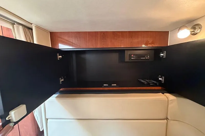 Slide: The Image of Interior of 2007 Sea Ray 300 Sundancer with open cabinet and stereo system. - 31