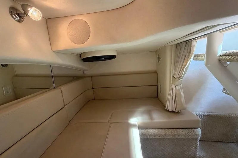 Slide: The Image of Interior cabin of 2007 Sea Ray 300 Sundancer with beige seating and curtains. - 33