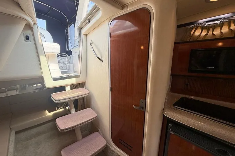 Slide: The Image of Interior of 2007 Sea Ray 300 Sundancer boat with stairs and wooden door. - 35