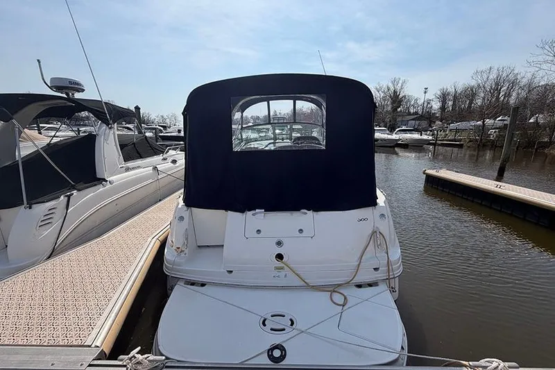 Slide: The Image of 2007 Sea Ray 300 Sundancer docked at marina, rear view with canopy. - 4