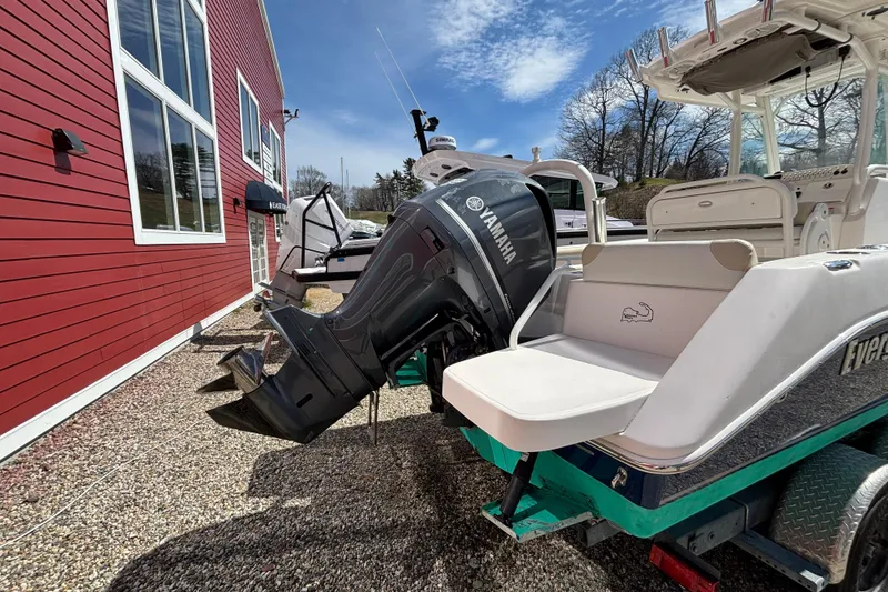 Slide: The Image of 2011 Everglades 230 Center Console boat with Yamaha engine, parked near a red building. - 10