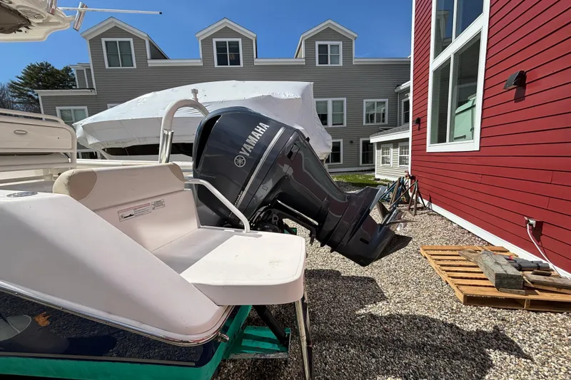 Slide: The Image of 2011 Everglades 230 Center Console boat with Yamaha outboard motor, parked near buildings. - 11
