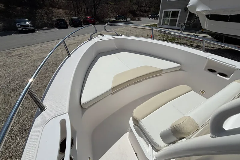 Slide: The Image of 2011 Everglades 230 Center Console boat interior with cushioned seating and railings. - 13
