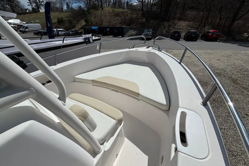 Slide: The Image of 2011 Everglades 230 Center Console boat with cushioned seating and stainless steel railings. - 14